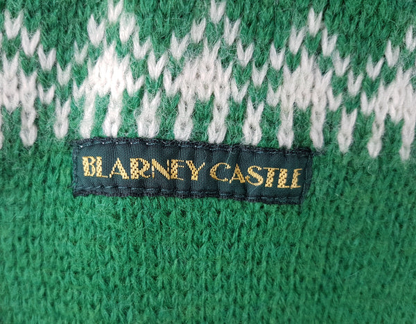 Vintage 1970s - 1980s Blarney Castle Irish fisherman’s green wool sweater with white shamrock and patterns on a mannequin
