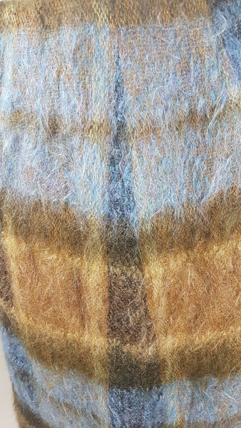 Fabric closeup for Vintage 1970s Andrew Stewart mohair and wool pencil skirt with a fuzzy plaid pattern in blue, brown, grey, and olive shown on mannequin