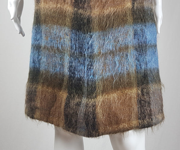 Vintage 1970s Andrew Stewart mohair and wool pencil skirt with a fuzzy plaid pattern in blue, brown, grey, and olive shown on mannequin