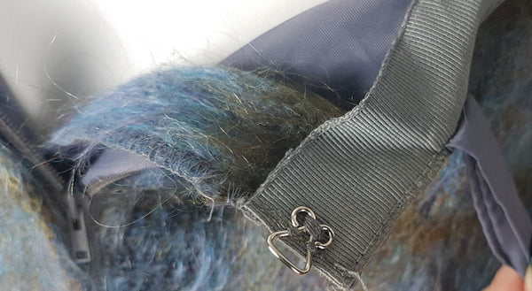 Hook and eye closure for Vintage 1970s Andrew Stewart mohair and wool pencil skirt with a fuzzy plaid pattern in blue, brown, grey, and olive shown on mannequin