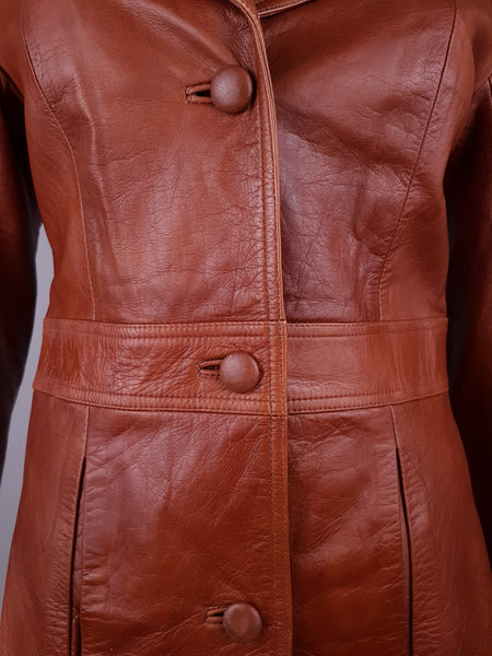 Front waist detail with three leather-covered buttons, vertical welt pockets and curved shaping seams
