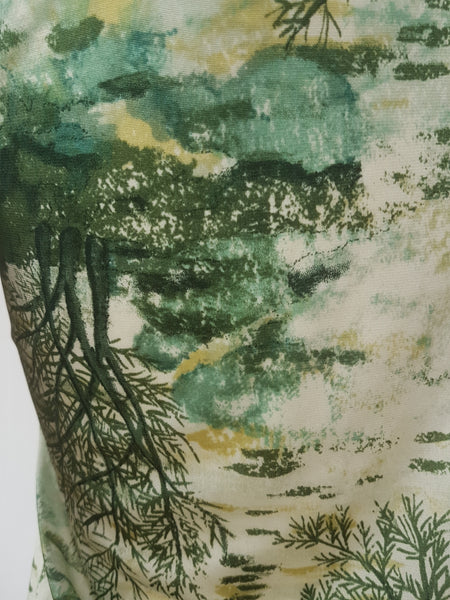 Vintage 1970s fitted long sleeve shirt with a pointed collar and green forest landscape print on a mannequin - print closeup