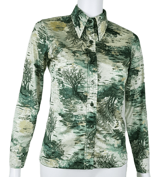 Vintage 1970s fitted long sleeve shirt with a pointed collar and green forest landscape print on a mannequin - front view