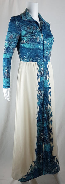 Vintage 1970s Missy House of Canada maxi dress with an aqua blue patterned bodice, long sleeves, pointed collar, and a white skirt with coordinating abstract panels shown on a mannequin