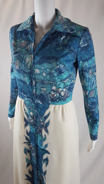 Vintage 1970s Missy House of Canada maxi dress with an aqua blue patterned bodice, long sleeves, pointed collar, and a white skirt with coordinating abstract panels shown on a mannequin