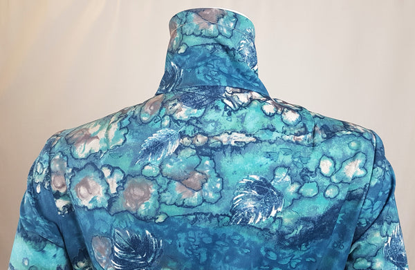 Collar and Shoulder view of Vintage 1970s Missy House of Canada maxi dress with an aqua blue patterned bodice, long sleeves, pointed collar, and a white skirt with coordinating abstract panels shown on a mannequin