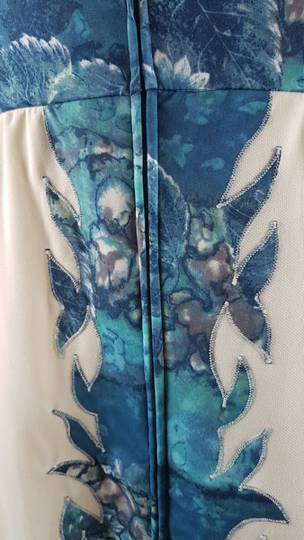Zipper view of Vintage 1970s Missy House of Canada maxi dress with an aqua blue patterned bodice, long sleeves, pointed collar, and a white skirt with coordinating abstract panels shown on a mannequin