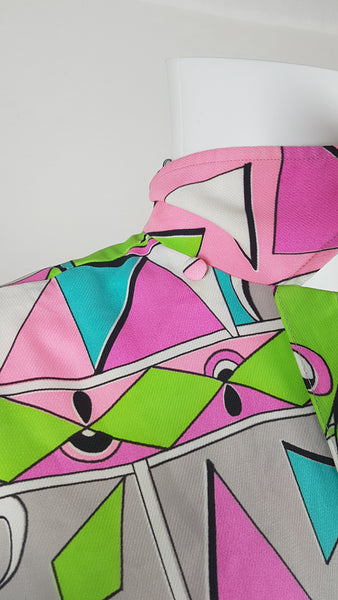 Back collar view of Front view of Vintage 1980s Lady Bayard shirt dress with short sleeves, a pointed collar, button front, matching tie belt, and a bold abstract geometric print in pink, turquoise, lime green, grey, and black displayed on a mannequin