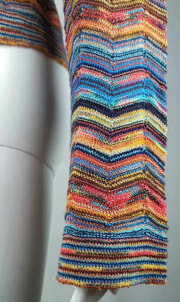 Close-up of the gently flared sleeve and intricate multicolour chevron knit on a vintage 1990s Holt Renfrew top.