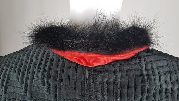 Vintage black brocade cropped bolero jacket with a fur collar, red satin lining, ribbon loop and decorative button displayed on a mannequin - back collar view