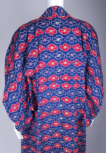 Vintage hand-stitched full-length Japanese cotton kimono displayed on a mannequin, with a bold blue, red and white lotus flower print - back shoulder and sleeve view