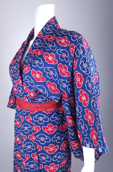 Vintage hand-stitched full-length Japanese cotton kimono displayed on a mannequin, with a bold blue, red and white lotus flower print - front sleeve and torso view