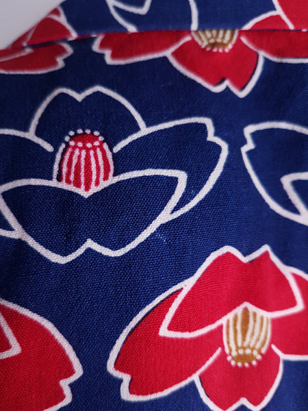 Fabric and print pattern closeup of Vintage hand-stitched full-length Japanese cotton kimono, with a bold blue, red and white lotus flower print 