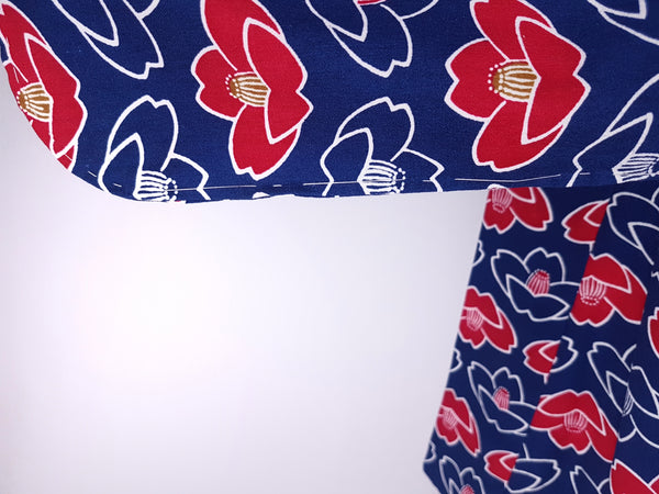 Vintage hand-stitched full-length Japanese cotton kimono displayed on a mannequin, with a bold blue, red and white lotus flower print - Sleeve view
