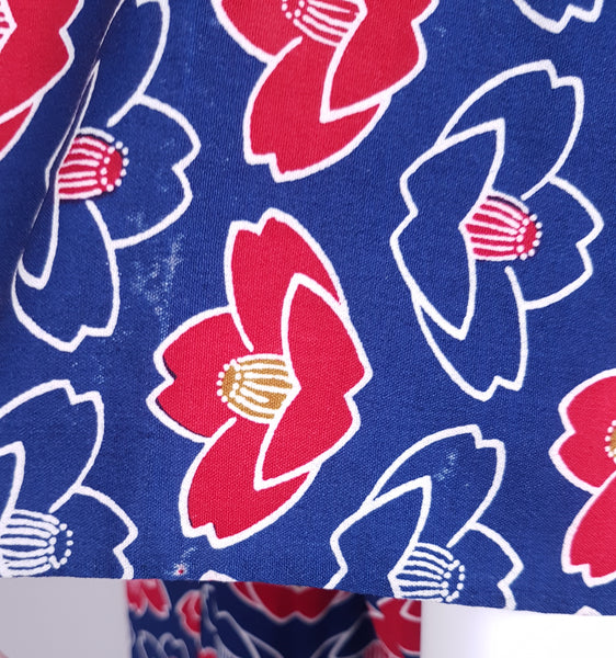 Fabric and print pattern closeup of Vintage hand-stitched full-length Japanese cotton kimono, with a bold blue, red and white lotus flower print - including slight imperfections in print