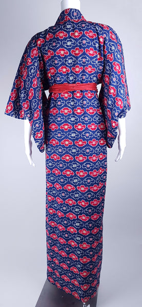 Vintage hand-stitched full-length Japanese cotton kimono displayed on a mannequin, with a bold blue, red and white lotus flower print - back view