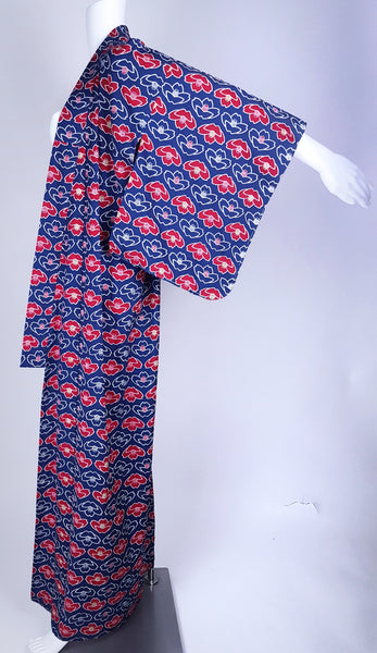 Vintage hand-stitched full-length Japanese cotton kimono displayed on a mannequin, with a bold blue, red and white lotus flower print - sleeve outstretched view