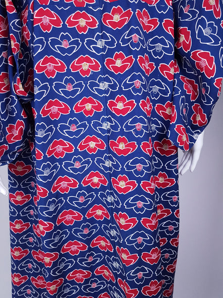 Vintage hand-stitched full-length Japanese cotton kimono displayed on a mannequin, with a bold blue, red and white lotus flower print - Back view