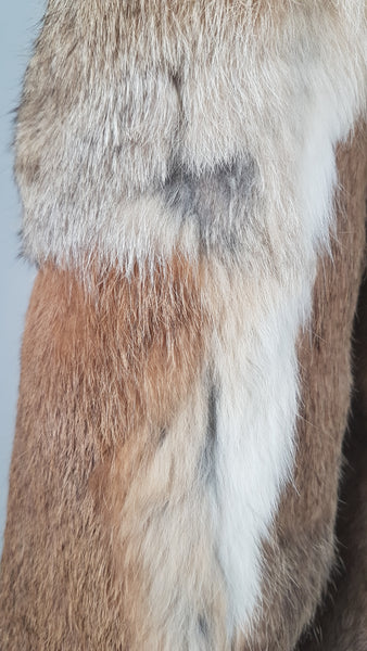 Close-up of a vintage late 1980s to early 1990s brown rabbit fur jacket on a mannequin, showing the sleeve and natural tonal variations - back view