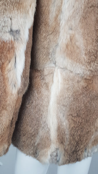 Close-up of a vintage late 1980s to early 1990s brown rabbit fur jacket on a mannequin, showing the sleeve and natural tonal variations - back view