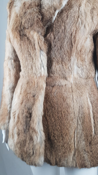 Vintage late 1980s to early 1990s brown rabbit fur jacket on a mannequin with a wide collar without the leather tie belt - front view
