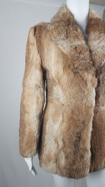 Close-up of a vintage  late 1980s to early 1990s brown rabbit fur jacket on a mannequin, showing the plush collar, long sleeve and natural tonal variations without the belt - front view