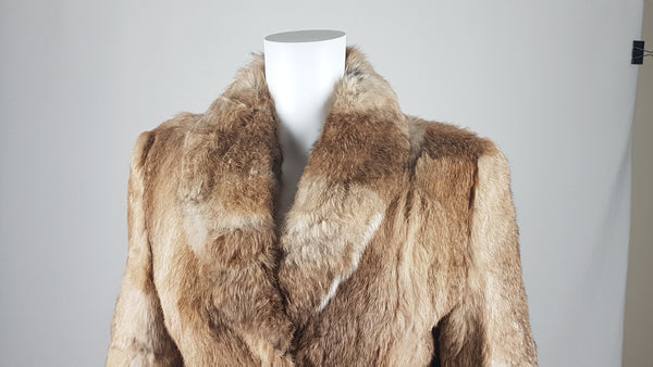 Close-up of a vintage  late 1980s to early 1990s brown rabbit fur jacket on a mannequin, showing the lapel and plush collar and natural tonal variations - front view