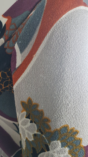 Minor fabric abrasions on Vintage Y2K cropped jacket featuring three-quarter sleeves and an abstract floral print in plum, rust, cream, black and grey