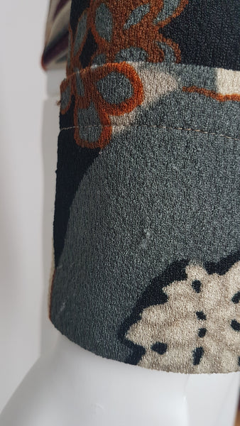 Minor fabric abrasions on Vintage Y2K cropped jacket featuring three-quarter sleeves and an abstract floral print in plum, rust, cream, black and grey