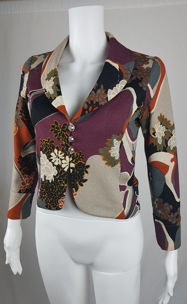 Vintage Y2K cropped jacket displayed on a mannequin, featuring three-quarter sleeves and an abstract floral print in plum, rust, cream, black and grey - side view