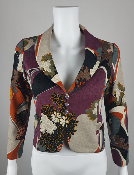 Vintage Y2K cropped jacket displayed on a mannequin, featuring three-quarter sleeves and an abstract floral print in plum, rust, cream, black and grey - front view
