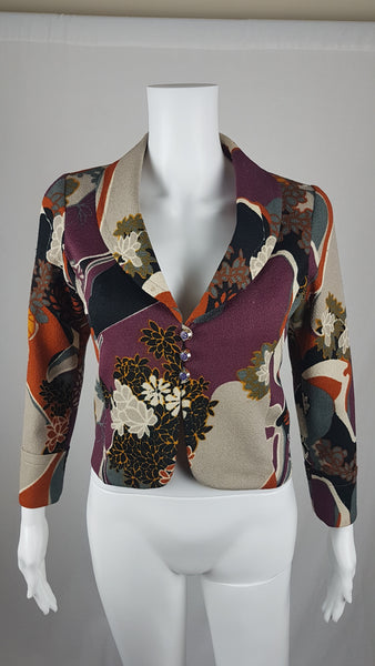 Vintage Y2K cropped jacket displayed on a mannequin, featuring three-quarter sleeves and an abstract floral print in plum, rust, cream, black and grey - front view