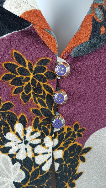 Vintage Y2K cropped jacket displayed on a mannequin, featuring three-quarter sleeves and an abstract floral print in plum, rust, cream, black and grey - purple accent buttons view