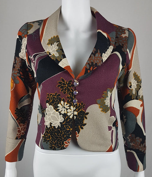 Vintage Y2K cropped jacket displayed on a mannequin, featuring three-quarter sleeves and an abstract floral print in plum, rust, cream, black and grey - front view