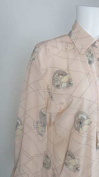 Vintage 1980s pastel peach Jac Dale shirt with long sleeves, a pointed collar, and an abstract grey fan print on a mannequin