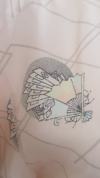 print detail on Vintage 1980s pastel peach Jac Dale shirt with long sleeves, a pointed collar, and an abstract grey fan print on a mannequin