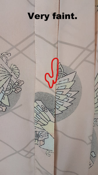 red outlined flaw/stain on Vintage 1980s pastel peach Jac Dale shirt with long sleeves, a pointed collar, and an abstract grey fan print on a mannequin