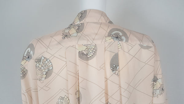 Vintage 1980s pastel peach Jac Dale shirt with long sleeves, a pointed collar, and an abstract grey fan print on a mannequin