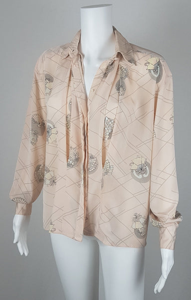 Vintage 1980s pastel peach Jac Dale shirt with long sleeves, a pointed collar, and an abstract grey fan print on a mannequin