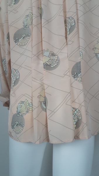 Vintage 1980s pastel peach Jac Dale shirt with long sleeves, a pointed collar, and an abstract grey fan print on a mannequin