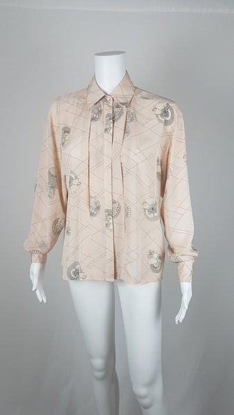 Vintage 1980s pastel peach Jac Dale shirt with long sleeves, a pointed collar, and an abstract grey fan print on a mannequin