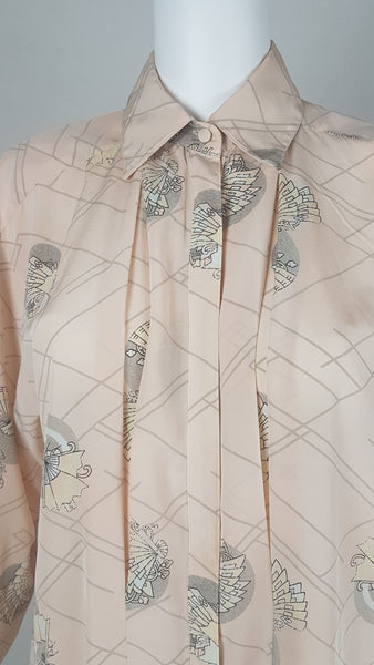 Vintage 1980s pastel peach Jac Dale shirt with long sleeves, a pointed collar, and an abstract grey fan print on a mannequin