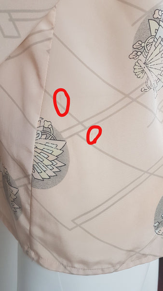 Red outline of flaw/stain on Vintage 1980s pastel peach Jac Dale shirt with long sleeves, a pointed collar, and an abstract grey fan print on a mannequin