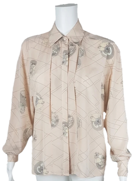 Vintage 1980s pastel peach Jac Dale shirt with long sleeves, a pointed collar, and an abstract grey fan print on a mannequin
